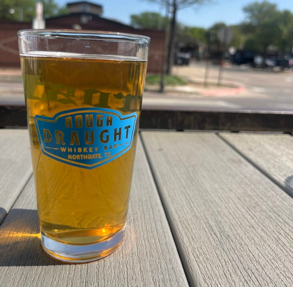 A Rough Draught pint glass on the patio